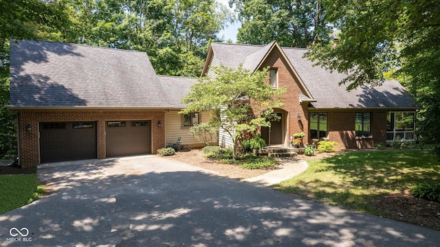 2450 S US-421, Zionsville, IN 46077 - view of front of home featuring brick siding, an attached garage, driveway, and a front lawn