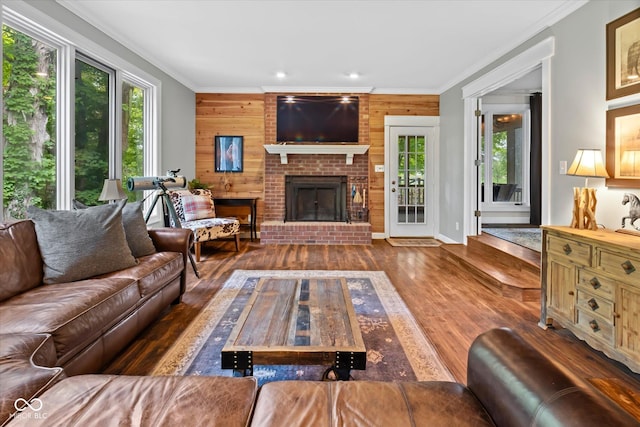 2450 S US-421, Zionsville, IN 46077 - living room with wooden walls, ornamental molding, a brick fireplace, and wood finished floors