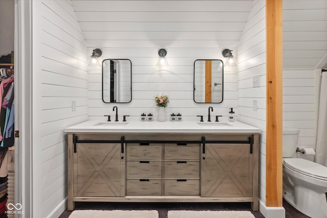 2450 S US-421, Zionsville, IN 46077 - full bath with a sink, toilet, wood walls, and double vanity