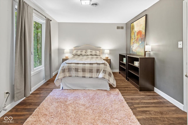 2450 S US-421, Zionsville, IN 46077 - bedroom with visible vents, baseboards, and dark wood-type flooring