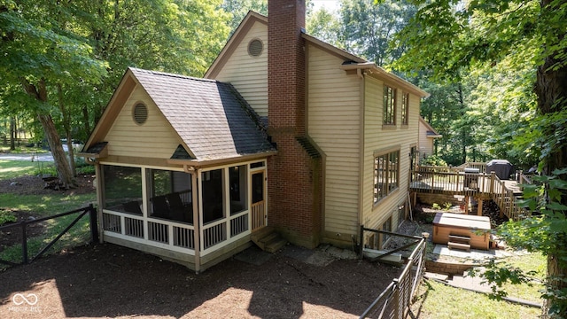 2450 S US-421, Zionsville, IN 46077 - rear view of property with a chimney, a wooden deck, a sunroom, a hot tub, and a fenced backyard