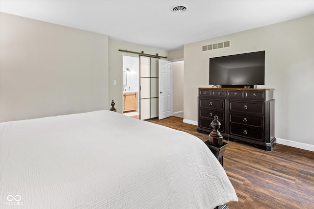 2450 S US-421, Zionsville, IN 46077 - bedroom featuring visible vents, a barn door, baseboards, and dark wood-type flooring