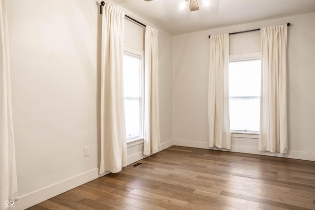 1451 N Grant Ave, Indianapolis, IN 46201 - spare room featuring wood finished floors, baseboards, and ceiling fan
