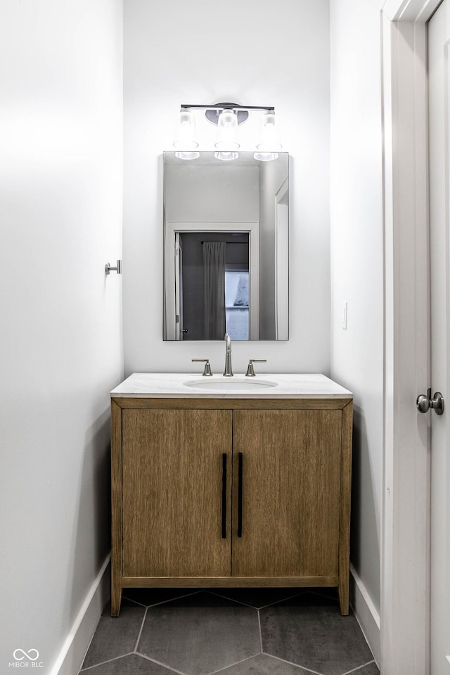 1451 N Grant Ave, Indianapolis, IN 46201 - bathroom featuring tile patterned floors, vanity, and baseboards