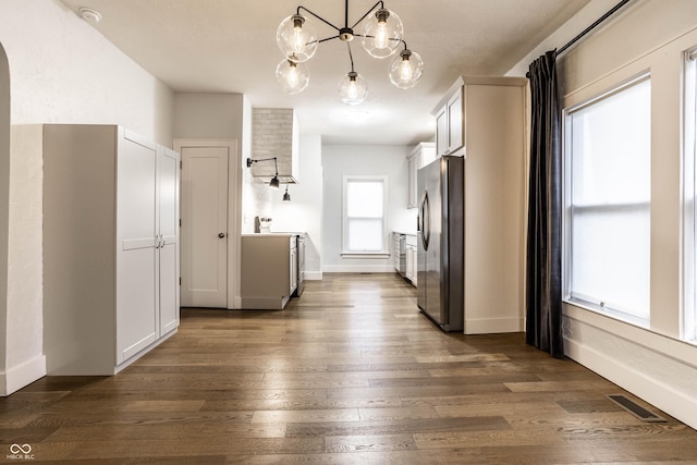 1451 N Grant Ave, Indianapolis, IN 46201 - kitchen featuring stainless steel appliances, dark wood finished floors, a chandelier, baseboards, and arched walkways