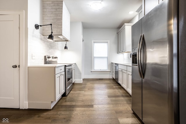1451 N Grant Ave, Indianapolis, IN 46201 - kitchen featuring appliances with stainless steel finishes, tasteful backsplash, dark wood finished floors, light countertops, and baseboards