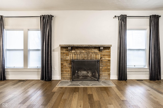 1451 N Grant Ave, Indianapolis, IN 46201 - detailed view of baseboards, a fireplace, and wood finished floors