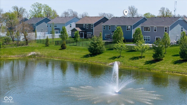 property view of water with fence and a residential view