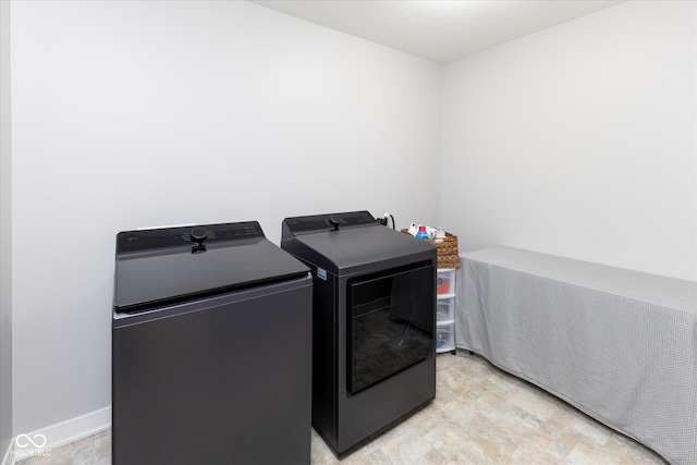 clothes washing area featuring washer and dryer and laundry area