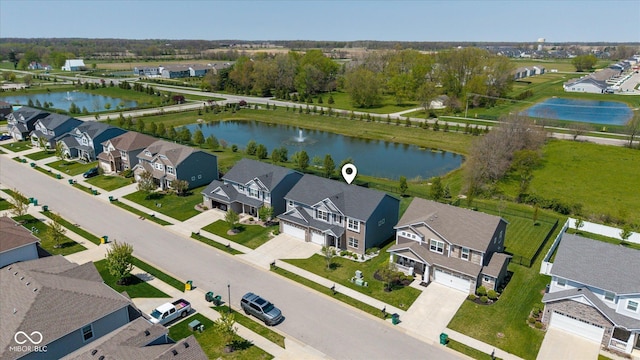 drone / aerial view featuring a water view and a residential view