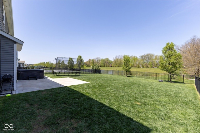 view of yard featuring a patio, a fenced backyard, and a trampoline