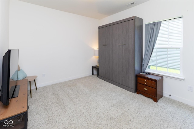 carpeted bedroom with baseboards and visible vents