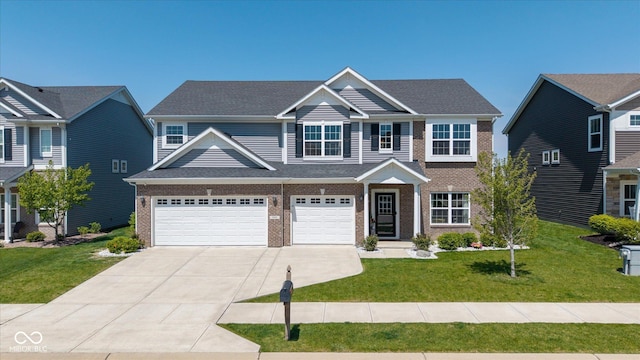 craftsman house with a garage, driveway, a front lawn, and brick siding