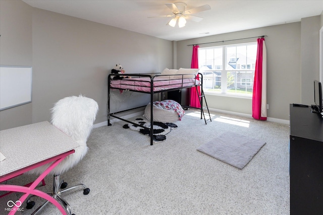 carpeted bedroom featuring baseboards and ceiling fan