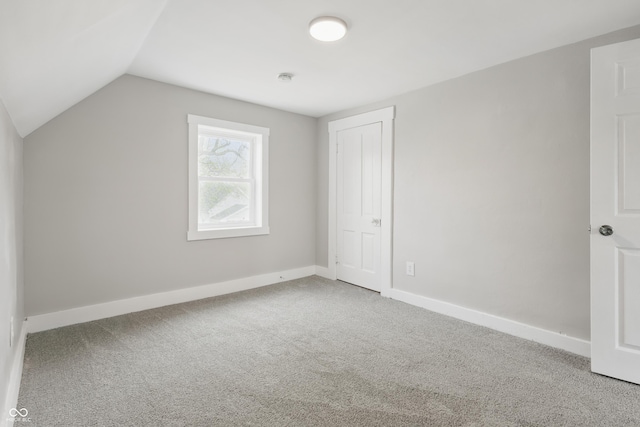 bonus room featuring baseboards, vaulted ceiling, and carpet