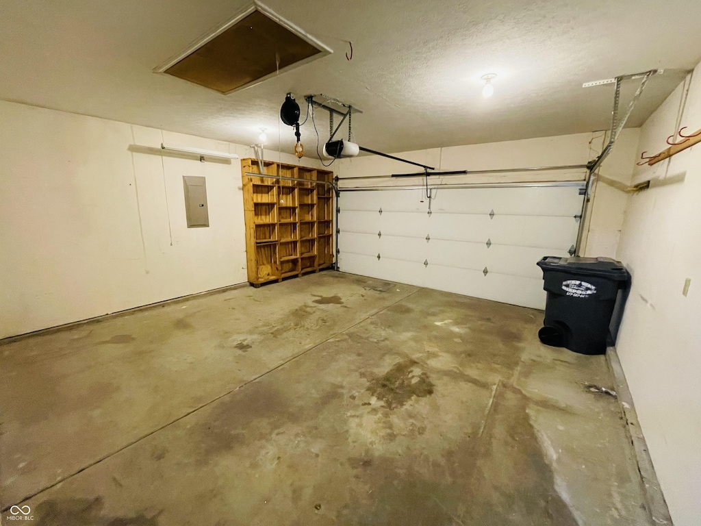 garage featuring a garage door opener and electric panel