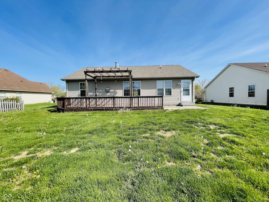 back of house featuring a yard, a pergola, and a wooden deck