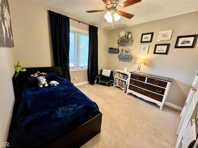 bedroom featuring baseboards, carpet flooring, a textured ceiling, and a ceiling fan
