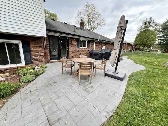 view of patio / terrace with outdoor dining area, fence, and grilling area
