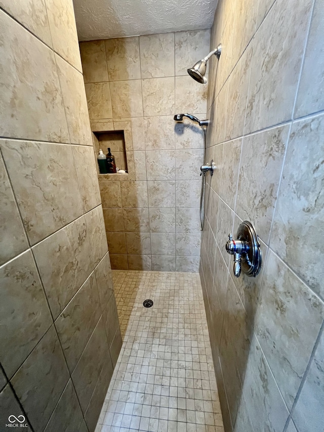 full bath featuring tiled shower