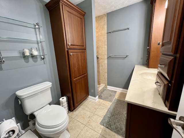 bathroom with vanity, tile patterned flooring, a stall shower, and toilet