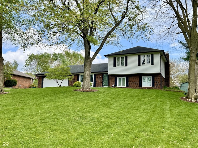 split level home with brick siding, a garage, a front lawn, and a chimney