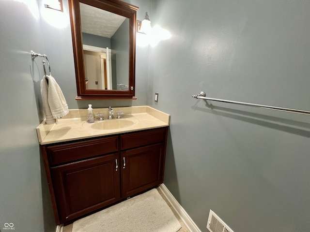 bathroom featuring vanity and visible vents