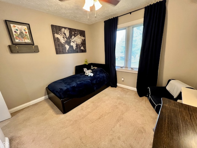 bedroom featuring baseboards, carpet flooring, a textured ceiling, and a ceiling fan