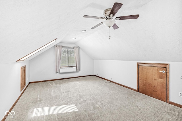 bonus room with ceiling fan, a textured ceiling, vaulted ceiling, baseboards, and carpet flooring