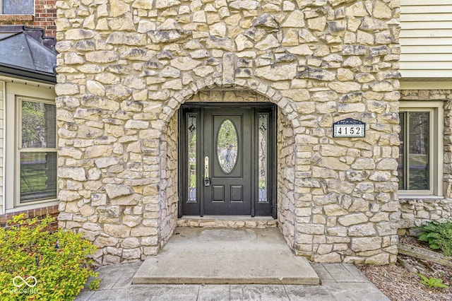 entrance to property with stone siding