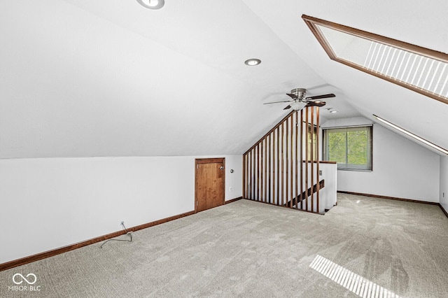 additional living space featuring a ceiling fan, baseboards, carpet, and lofted ceiling
