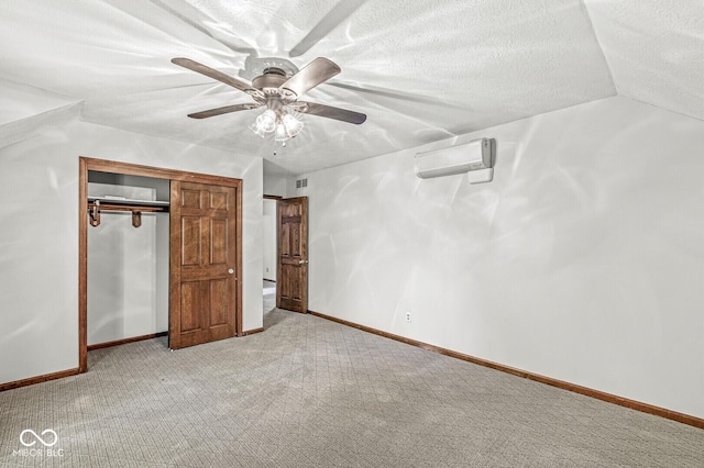 unfurnished bedroom with a ceiling fan, visible vents, light colored carpet, a wall mounted AC, and a closet