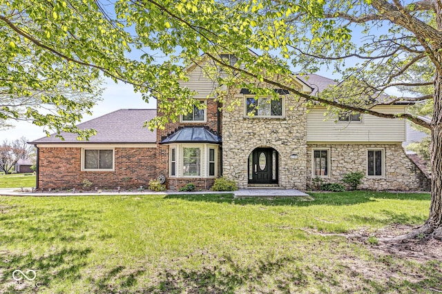 traditional home with roof with shingles, a front lawn, and stone siding