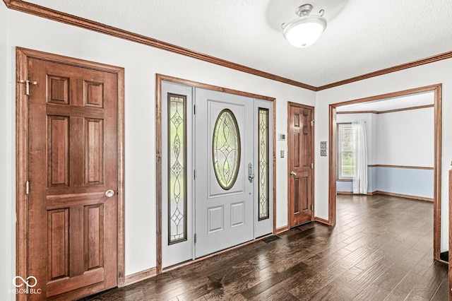foyer featuring baseboards, ornamental molding, a textured ceiling, and dark wood-type flooring