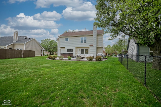 back of house with fence, a chimney, and a yard