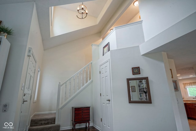 entrance foyer featuring a high ceiling, a notable chandelier, recessed lighting, baseboards, and stairway