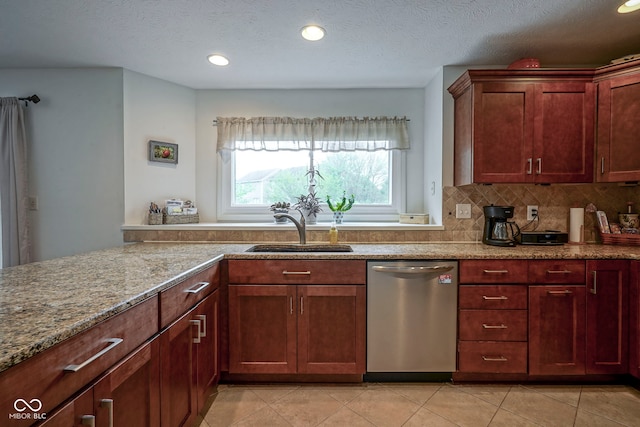 kitchen with stainless steel dishwasher, decorative backsplash, recessed lighting, light stone counters, and a sink