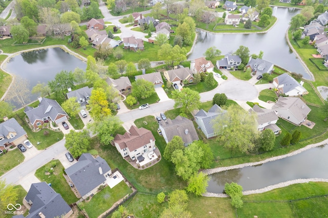 drone / aerial view with a residential view and a water view
