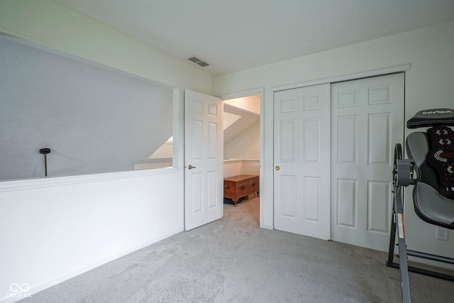 interior space featuring carpet floors, a closet, and visible vents