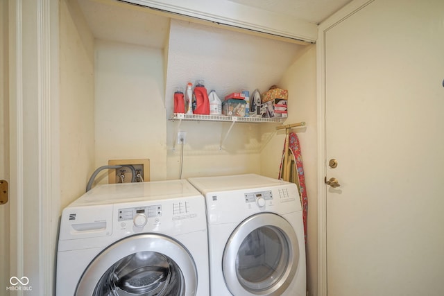 clothes washing area featuring separate washer and dryer and laundry area