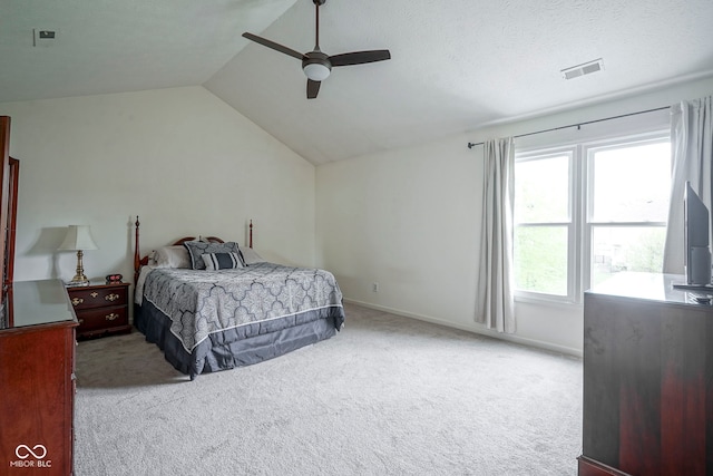 carpeted bedroom featuring visible vents, a ceiling fan, baseboards, and vaulted ceiling