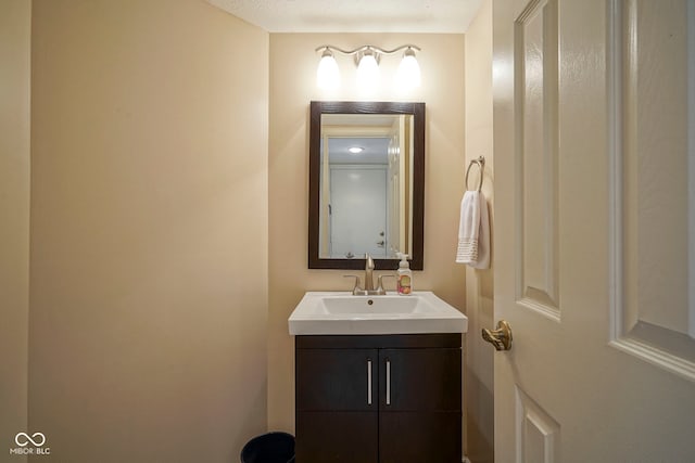 half bathroom featuring vanity