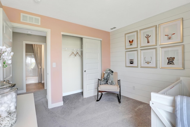 bedroom with baseboards, light carpet, a closet, and visible vents