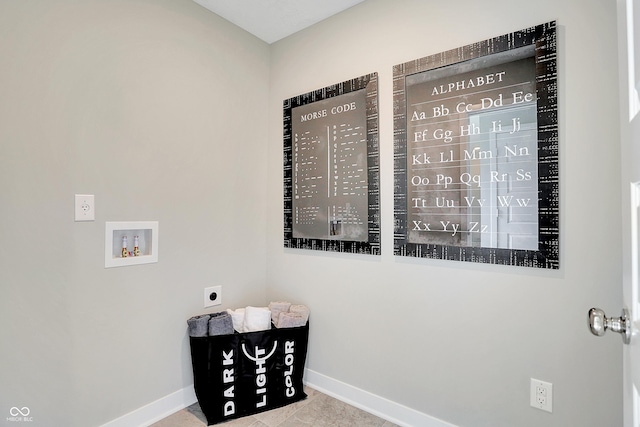 interior space featuring electric dryer hookup, tile patterned flooring, washer hookup, and baseboards