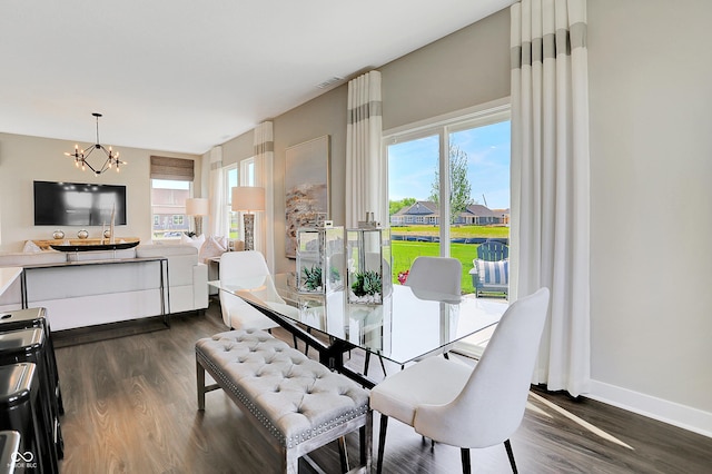 dining room with a wealth of natural light, visible vents, a notable chandelier, and dark wood-type flooring