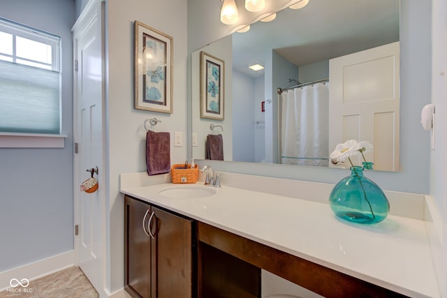 bathroom featuring vanity and baseboards
