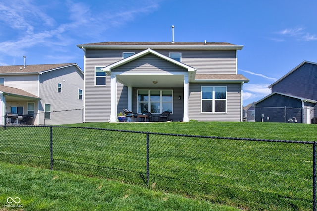 back of property featuring a lawn and a fenced backyard