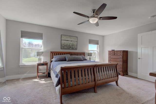 carpeted bedroom featuring a ceiling fan and baseboards