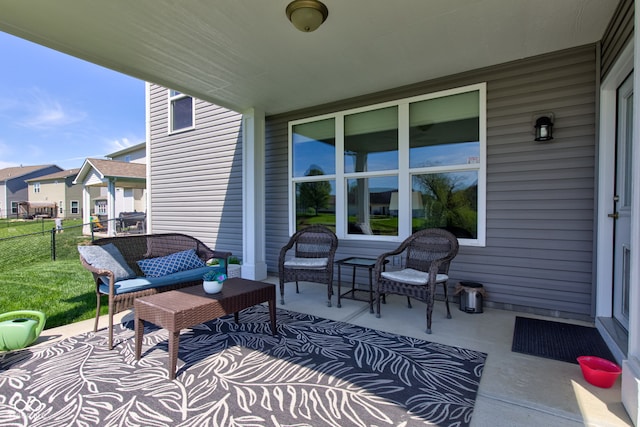 view of patio with fence and a residential view