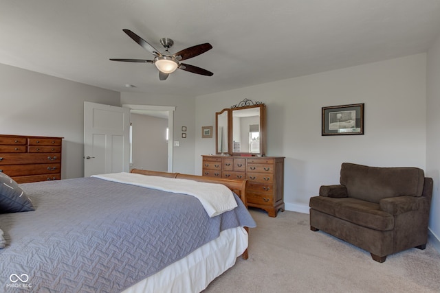 bedroom featuring light colored carpet, a ceiling fan, and baseboards